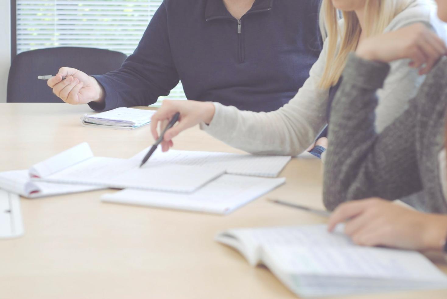Business professional working on financial planning with calculator and documents in organized workspace